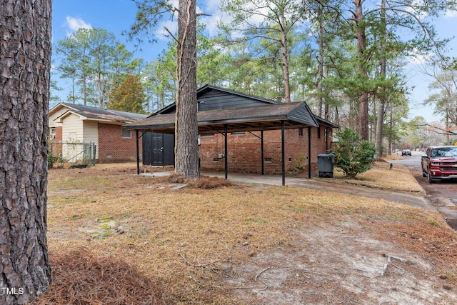 back of house with a carport