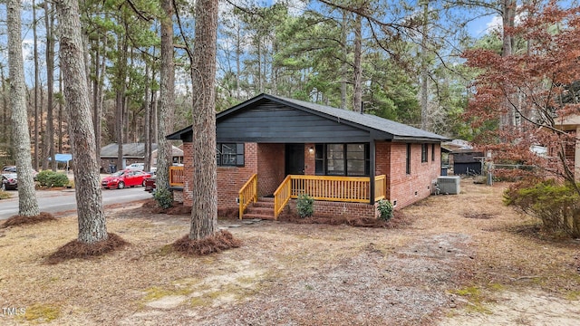 view of front facade with cooling unit and covered porch