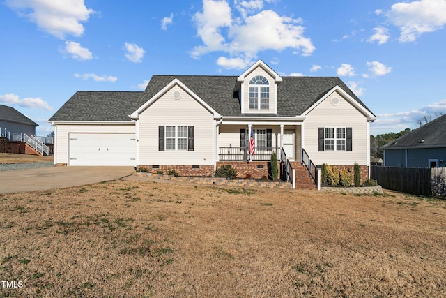 view of front of house with a porch, a garage, and a front lawn