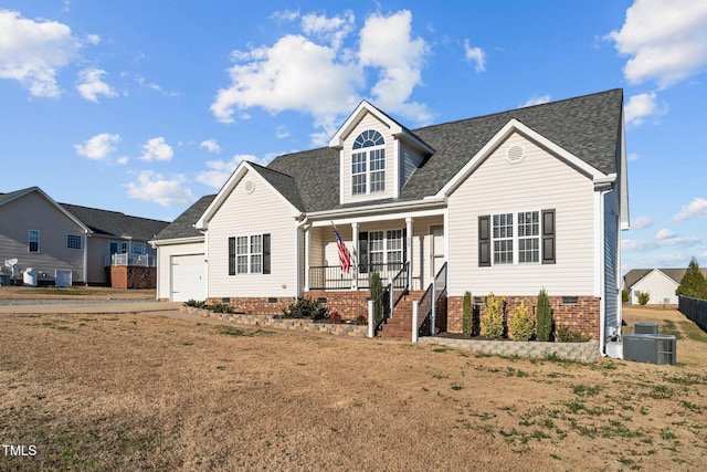 view of front of property featuring a garage, central AC unit, covered porch, and a front yard