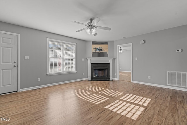 unfurnished living room with ceiling fan and light wood-type flooring