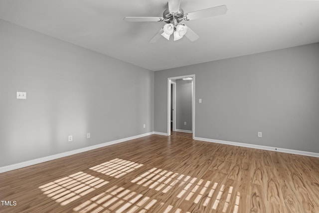 empty room featuring ceiling fan and hardwood / wood-style floors