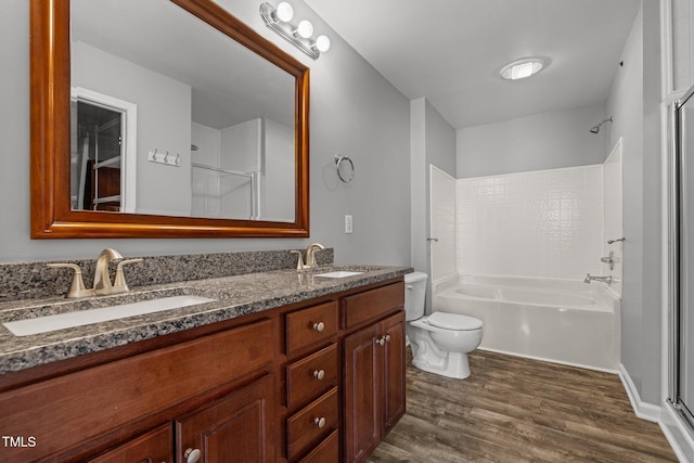 full bathroom featuring hardwood / wood-style flooring, vanity, shower / washtub combination, and toilet