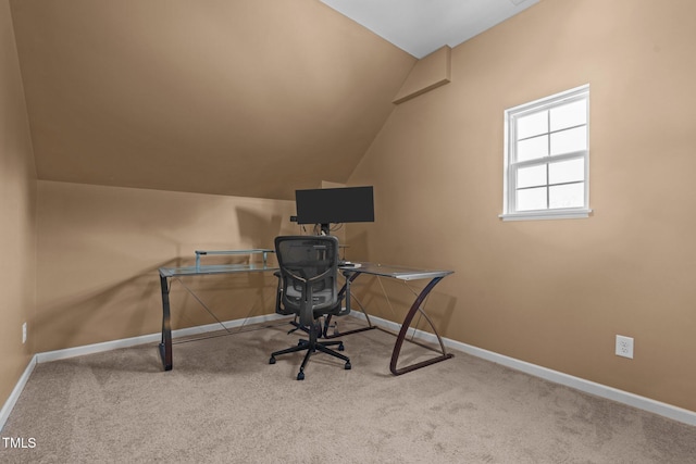 unfurnished office featuring lofted ceiling and light carpet