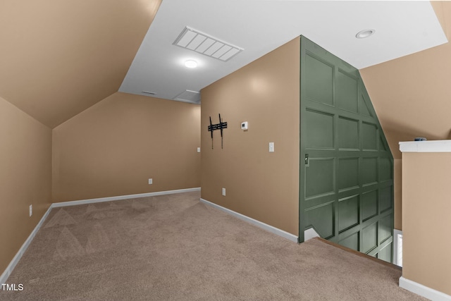 additional living space with vaulted ceiling and light carpet