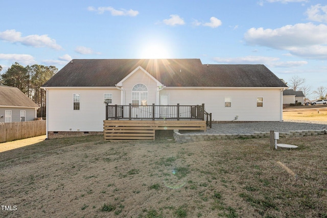 back of house with a wooden deck and a yard