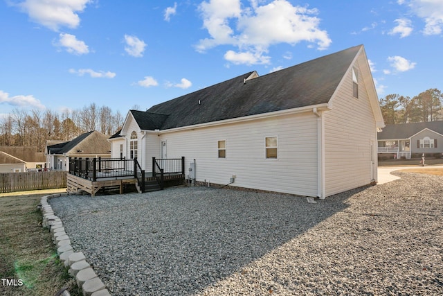 rear view of house with a wooden deck