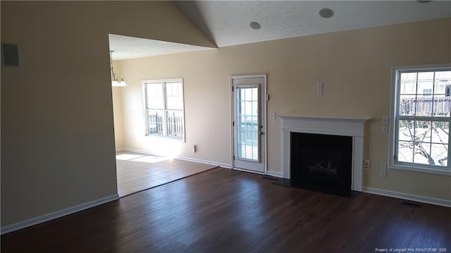 3922 Tasha Dr, Hope Mills, NC 28348 - unfurnished living room with lofted ceiling, plenty of natural light, a textured ceiling, and dark hardwood / wood-style flooring