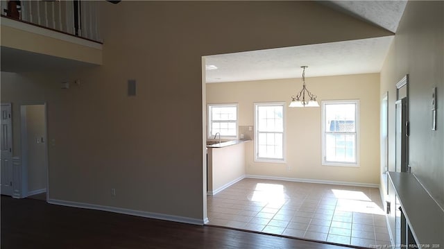 3922 Tasha Dr, Hope Mills, NC 28348 - unfurnished room with hardwood / wood-style floors and a chandelier