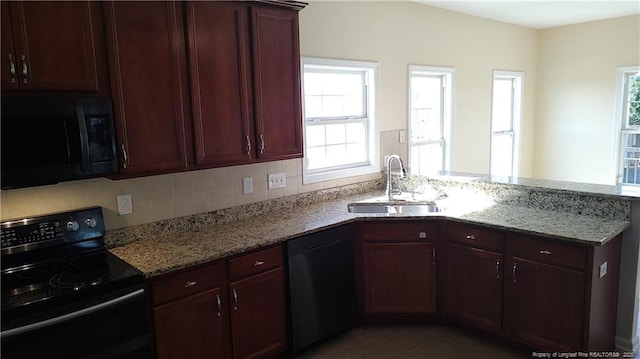 3922 Tasha Dr, Hope Mills, NC 28348 - kitchen featuring black appliances, sink, tile patterned flooring, light stone counters, and kitchen peninsula