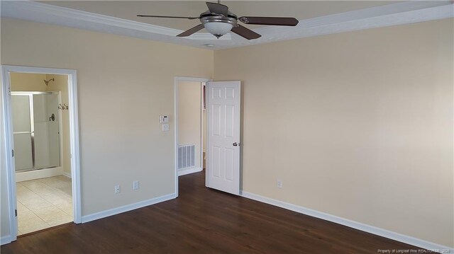 3922 Tasha Dr, Hope Mills, NC 28348 - unfurnished bedroom featuring dark hardwood / wood-style flooring, ensuite bath, and ceiling fan