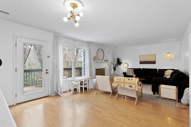 dining space featuring hardwood / wood-style flooring and an inviting chandelier