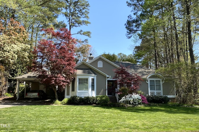 view of front of house with a carport and a front lawn