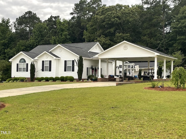 view of front of property with roof with shingles, concrete driveway, and a front yard