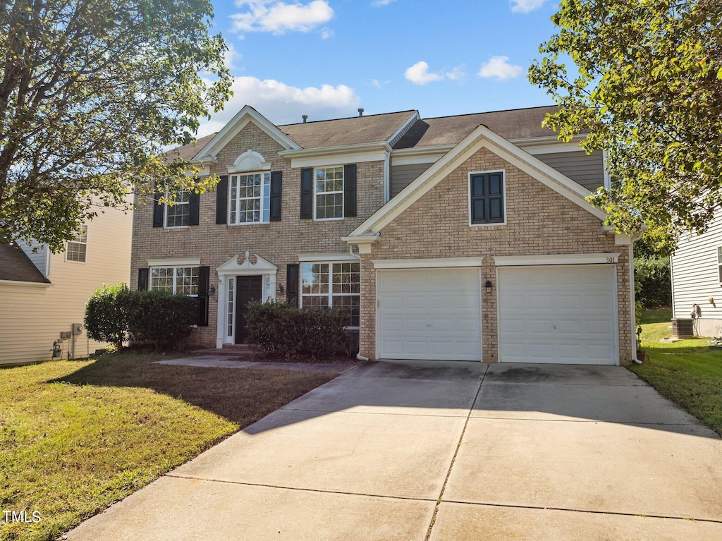 view of front of property with a garage and a front lawn