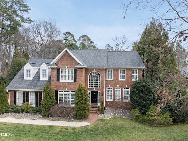 colonial-style house with a front yard