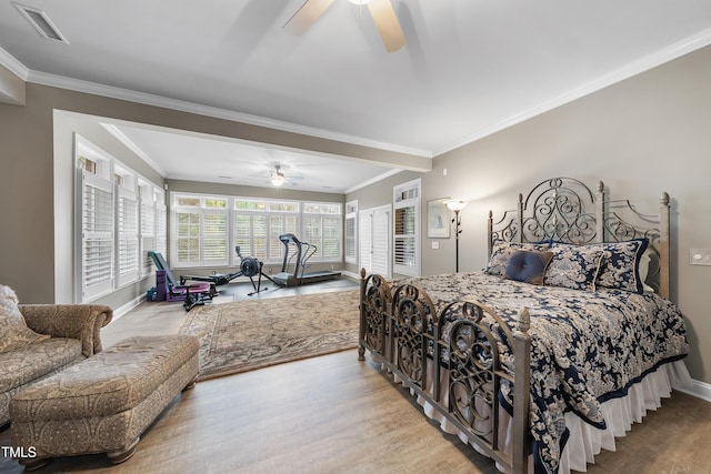 bedroom with ceiling fan, ornamental molding, and light wood-type flooring