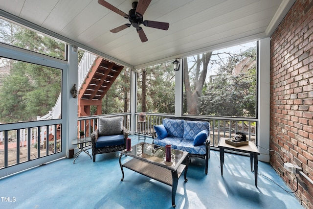 sunroom / solarium featuring ceiling fan