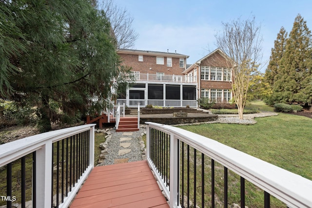 deck with a lawn and a sunroom