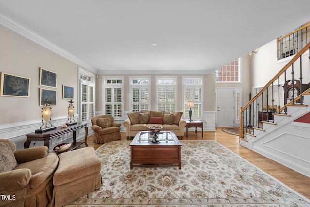 living room featuring crown molding and light hardwood / wood-style flooring