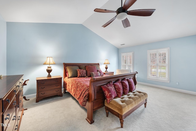 bedroom with vaulted ceiling, light carpet, and ceiling fan