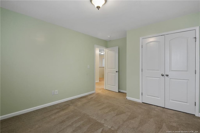 323 River Oak St, Spring Lake, NC 28390 - unfurnished bedroom with carpet, baseboards, and a closet