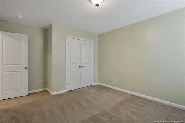 323 River Oak St, Spring Lake, NC 28390 - unfurnished bedroom with carpet flooring, baseboards, and a closet