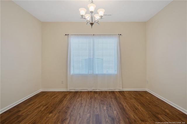 323 River Oak St, Spring Lake, NC 28390 - empty room with a notable chandelier, baseboards, and wood finished floors