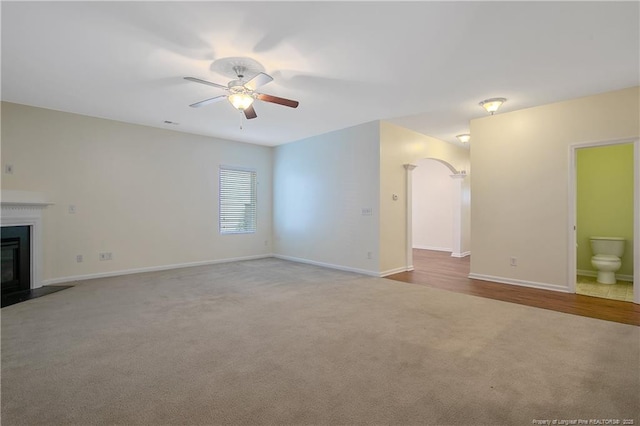 323 River Oak St, Spring Lake, NC 28390 - unfurnished living room featuring ceiling fan, carpet flooring, arched walkways, and baseboards