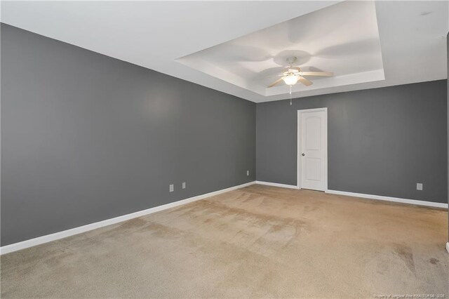 323 River Oak St, Spring Lake, NC 28390 - carpeted empty room with ceiling fan, a raised ceiling, and baseboards