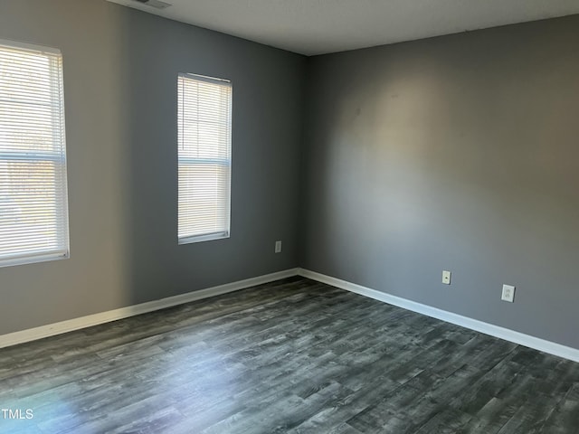 empty room featuring dark hardwood / wood-style flooring