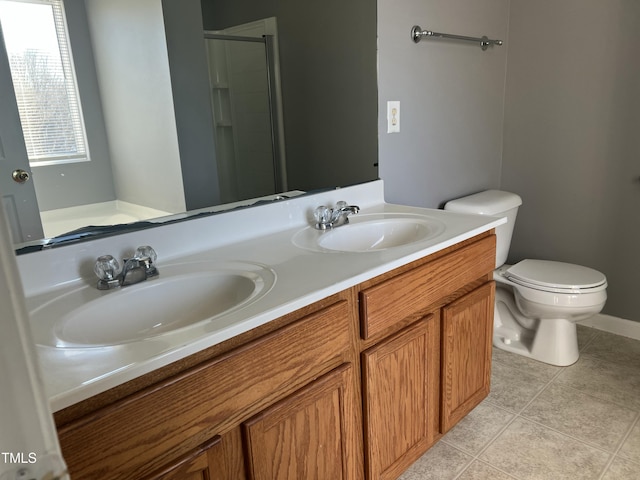 bathroom featuring vanity, toilet, a shower with shower door, and tile patterned flooring