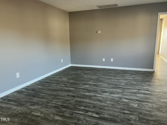 unfurnished room featuring dark hardwood / wood-style floors