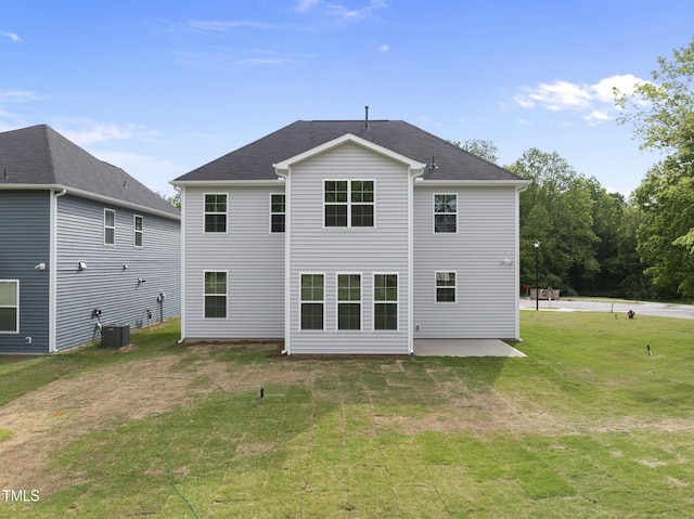 back of property featuring central AC, a patio, and a yard