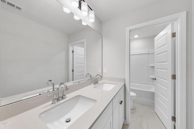 full bathroom featuring visible vents, toilet, double vanity, and a sink