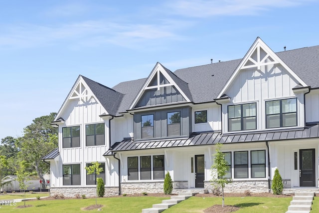905 Myers Point Dr, Morrisville, NC 27560 - modern farmhouse style home featuring a standing seam roof, a shingled roof, and a front lawn