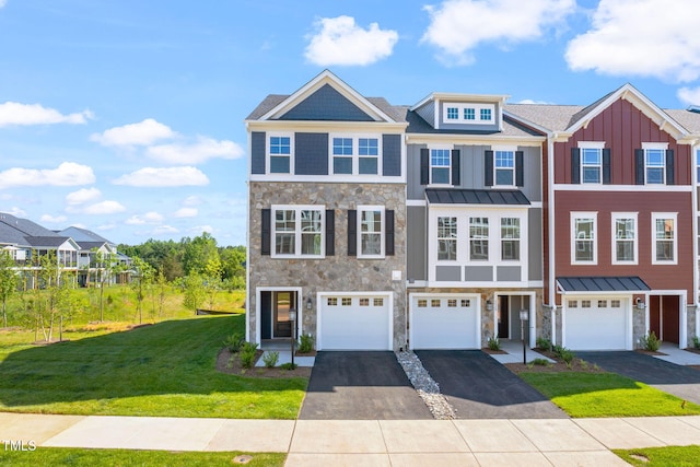 multi unit property featuring a garage and a front yard