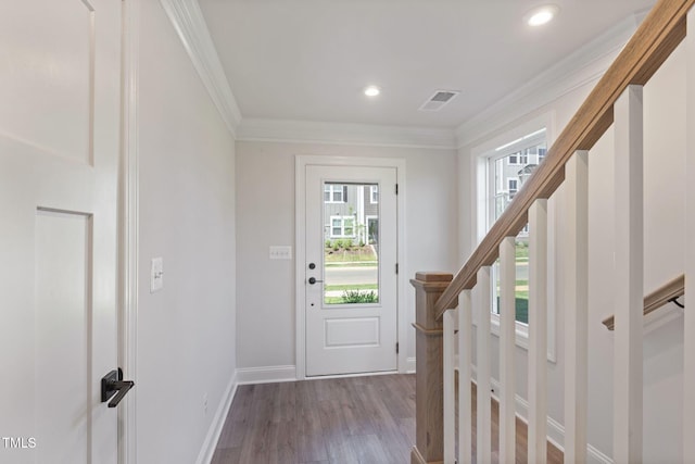 doorway featuring ornamental molding and light wood-type flooring