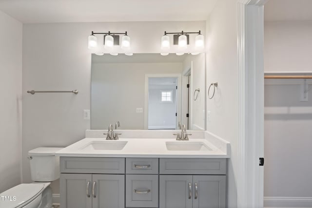 bathroom featuring vanity and toilet
