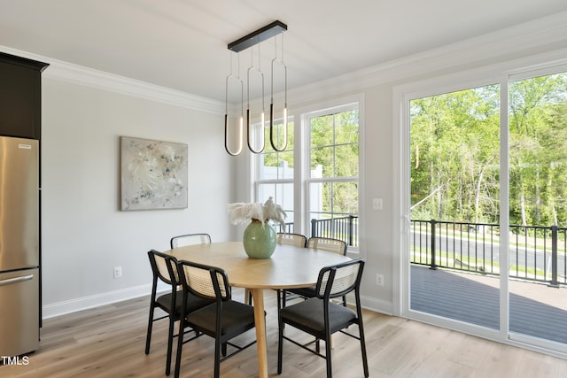 dining area with hardwood / wood-style flooring and crown molding