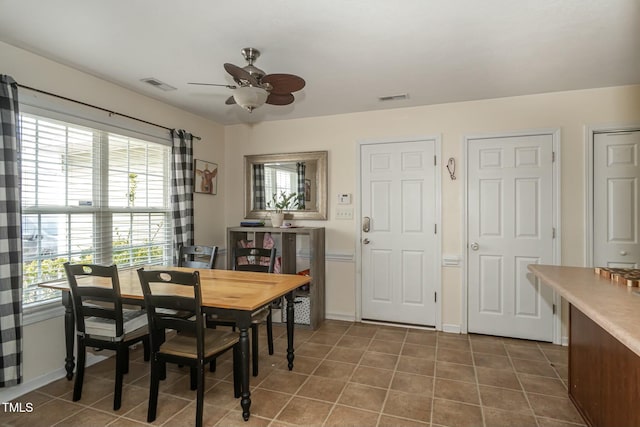 tiled dining room with ceiling fan