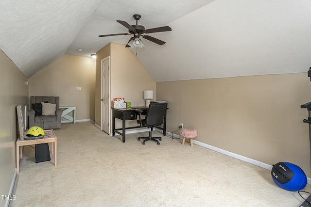 office area with vaulted ceiling, light colored carpet, ceiling fan, and a textured ceiling