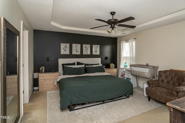 bedroom featuring ceiling fan and a tray ceiling