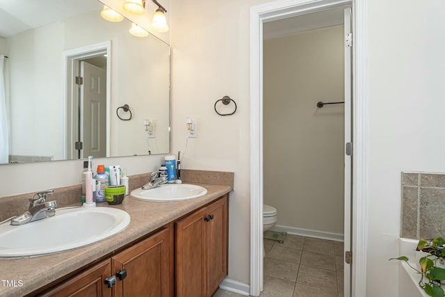 bathroom with vanity, tile patterned floors, and toilet