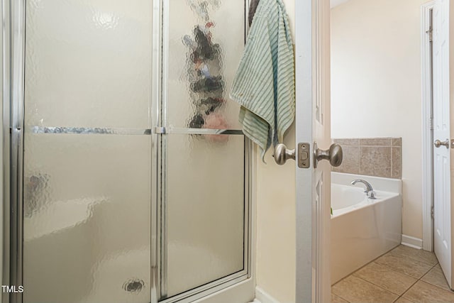 bathroom with independent shower and bath and tile patterned flooring