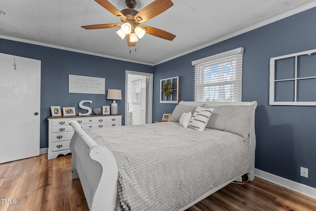 bedroom with ornamental molding, ceiling fan, dark hardwood / wood-style flooring, and ensuite bath