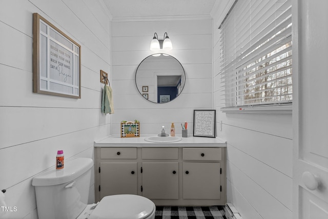 bathroom with crown molding, a baseboard heating unit, vanity, and toilet