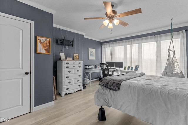 bedroom with ceiling fan, crown molding, light hardwood / wood-style floors, and a textured ceiling