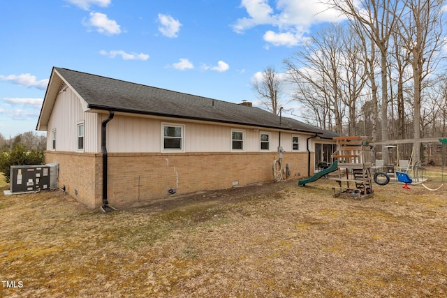 view of property exterior featuring a playground, a yard, and central AC