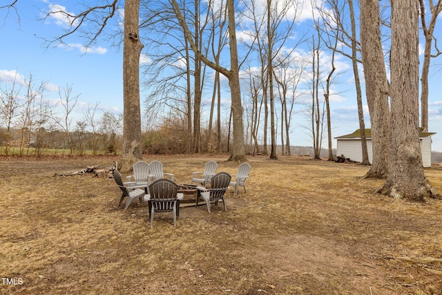 view of yard with an outdoor fire pit